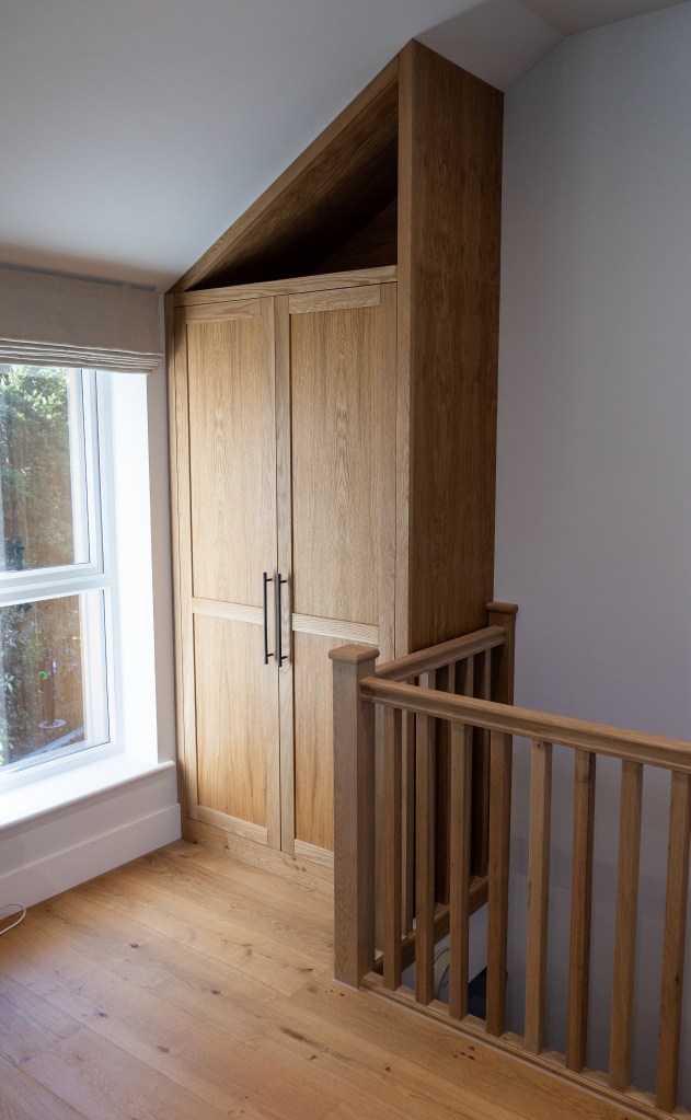 Bespoke Oak fitted Cabinet in an awkward space above some stairs
