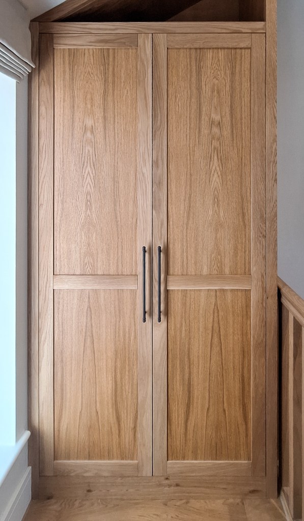 Bespoke Oak fitted Cabinet in an awkward space above some stairs