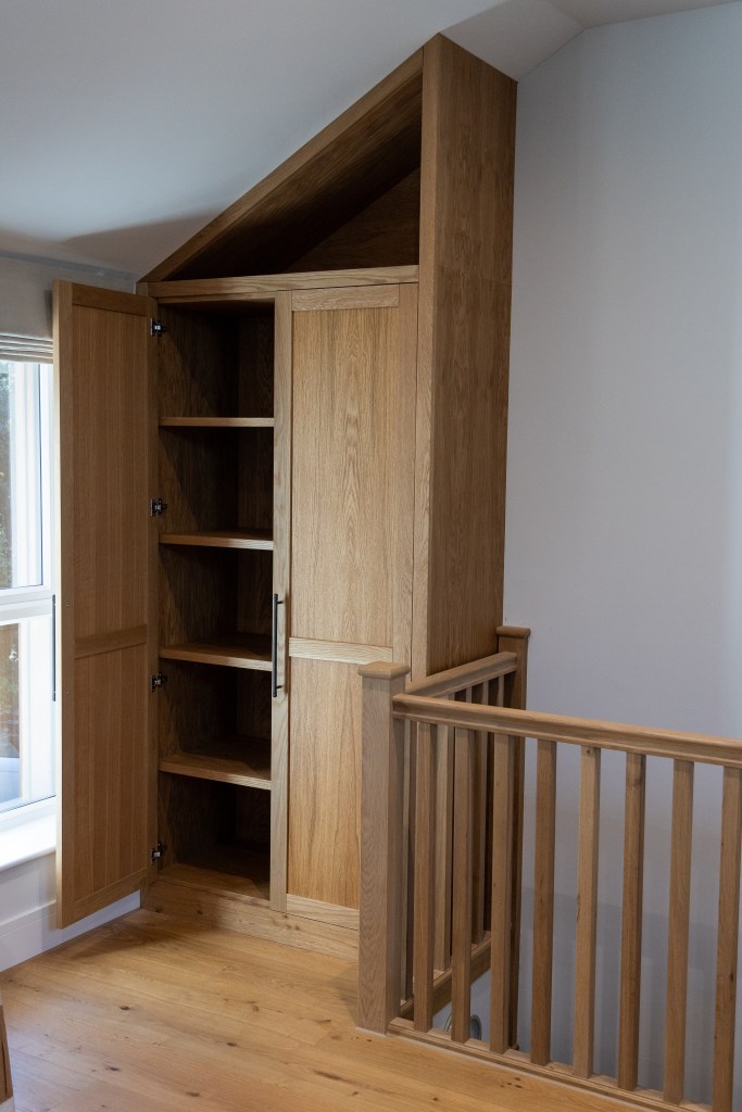 Bespoke Oak fitted Cabinet in an awkward space above some stairs
