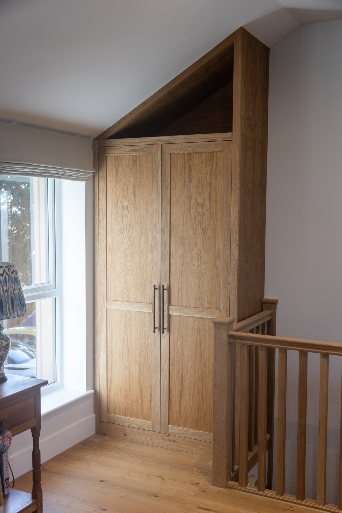 Bespoke Oak fitted Cabinet in an awkward space above some stairs