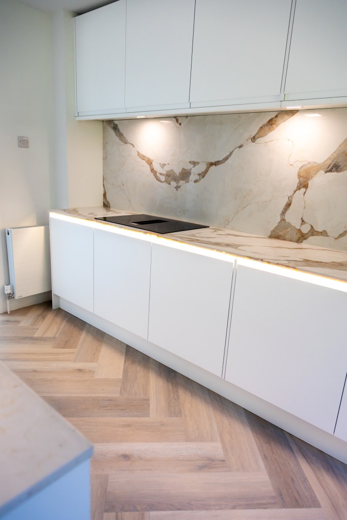 New kitchen with quartz worktops and luxury vinyl tile herringbone flooring