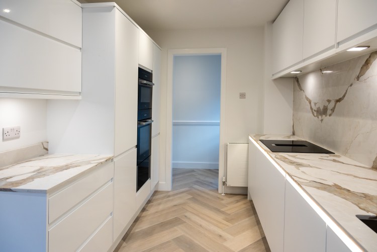 New kitchen with quartz worktops and luxury vinyl tile herringbone flooring