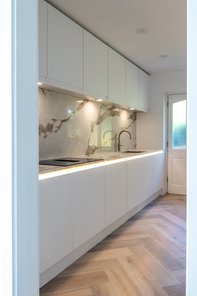 New kitchen with quartz worktops and luxury vinyl tile herringbone flooring