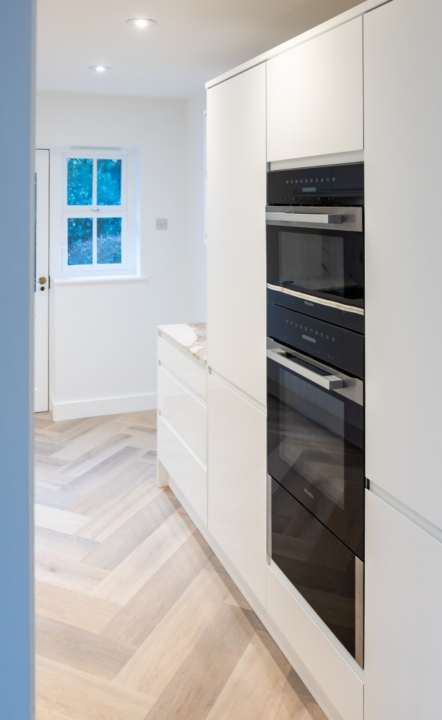 New kitchen with quartz worktops and luxury vinyl tile herringbone flooring